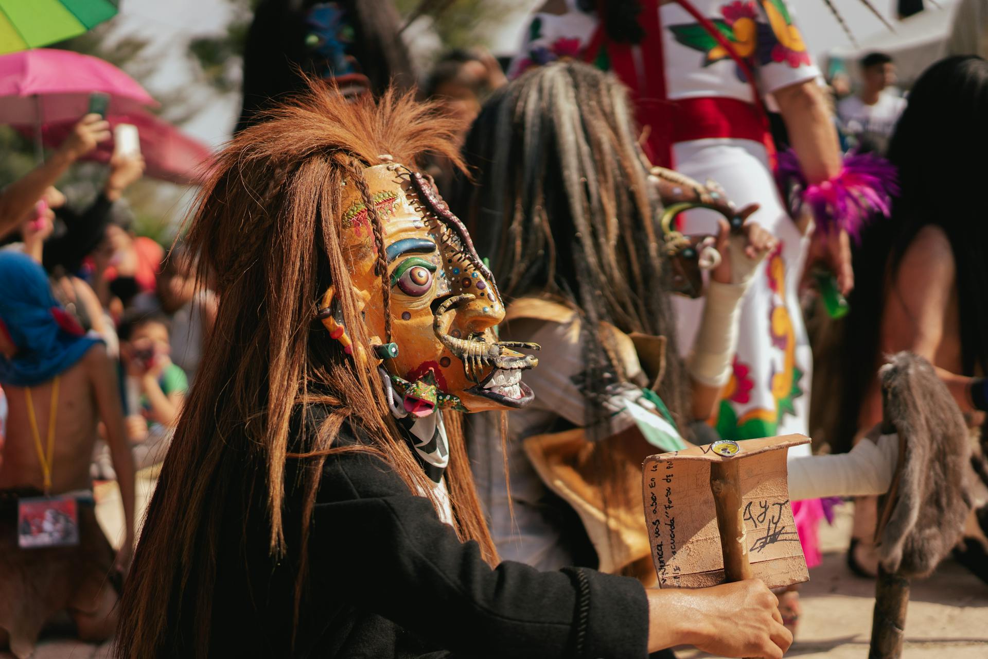 Close up of a Person in a Carnival Mask and Crowd in Background