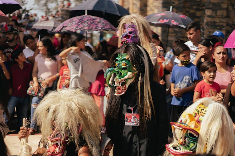 People In Carnival Masks In Crowd