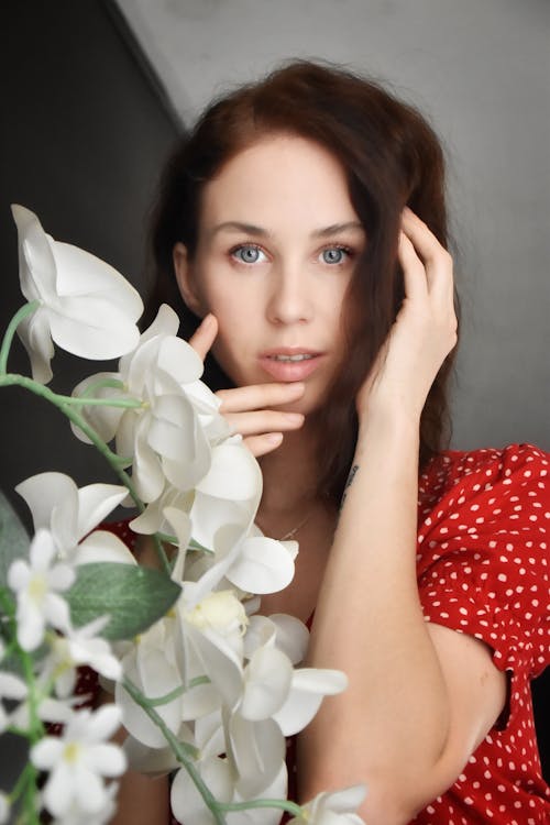 Woman Posing Beside White Flowers