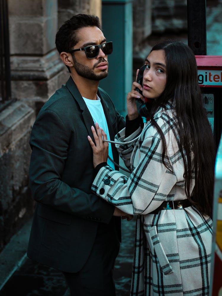 Young Couple By The Telephone On The Street 