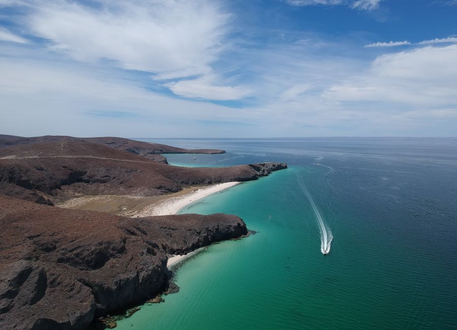 A stunning aerial view of the coastline in Baja California Sur, Mexico, showcasing cliffs and turquoise waters.