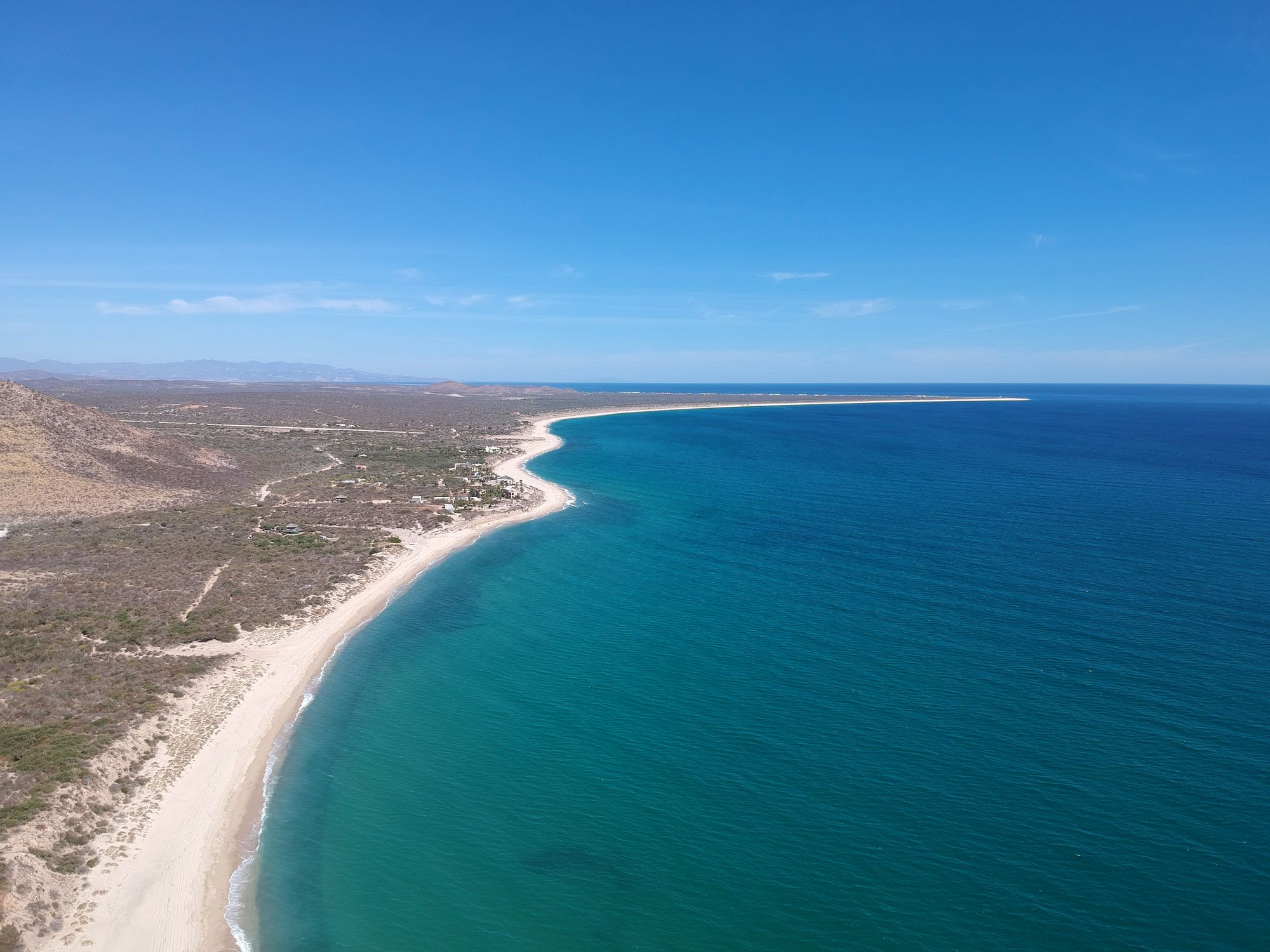 Stunning aerial shot of the coastline in Baja California Sur, Mexico, with clear blue waters and sandy beaches.