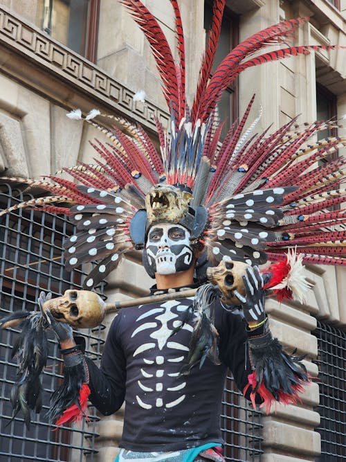 A Man in a Headdress and Skeleton Costume