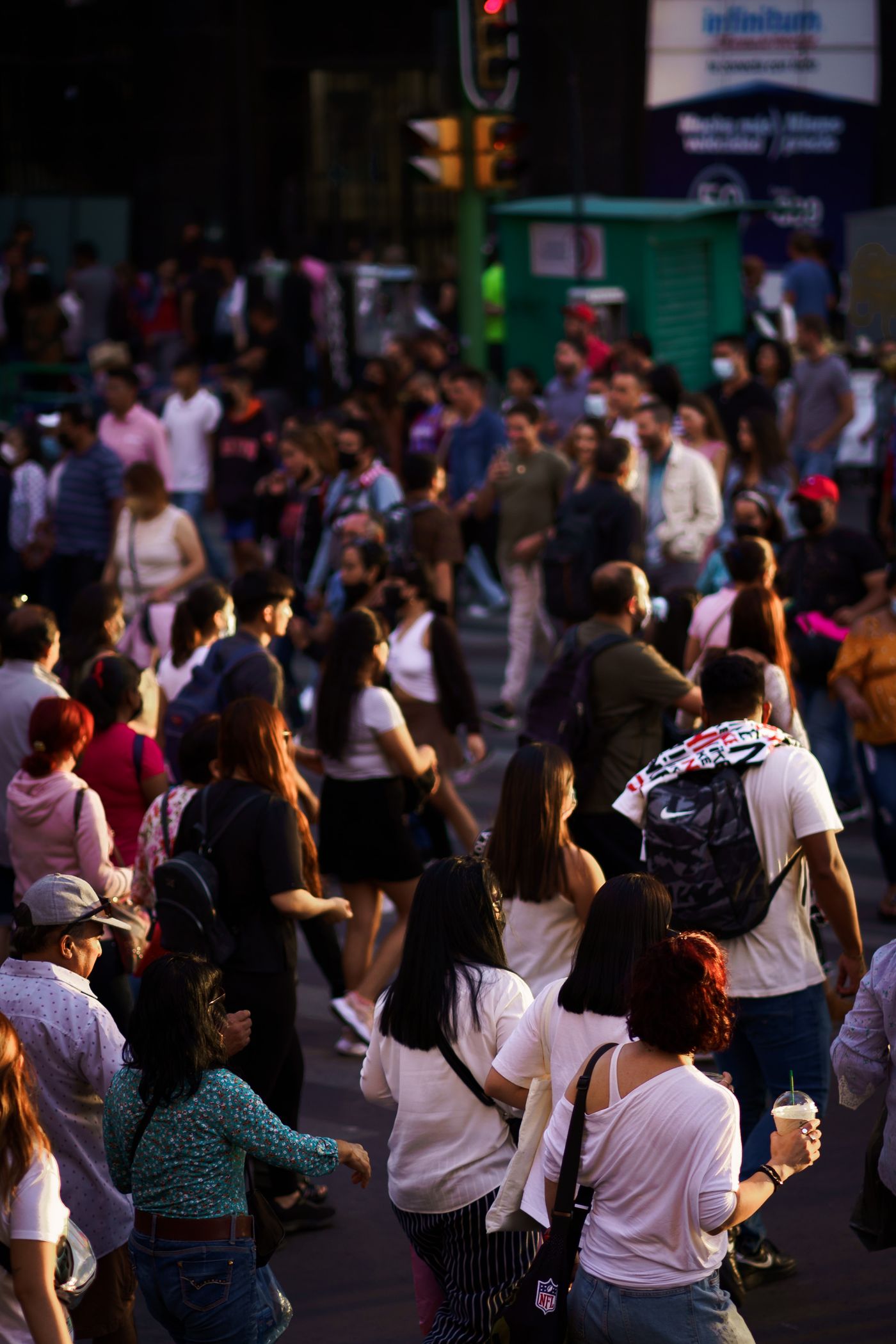 Crowd of people crossing a city street