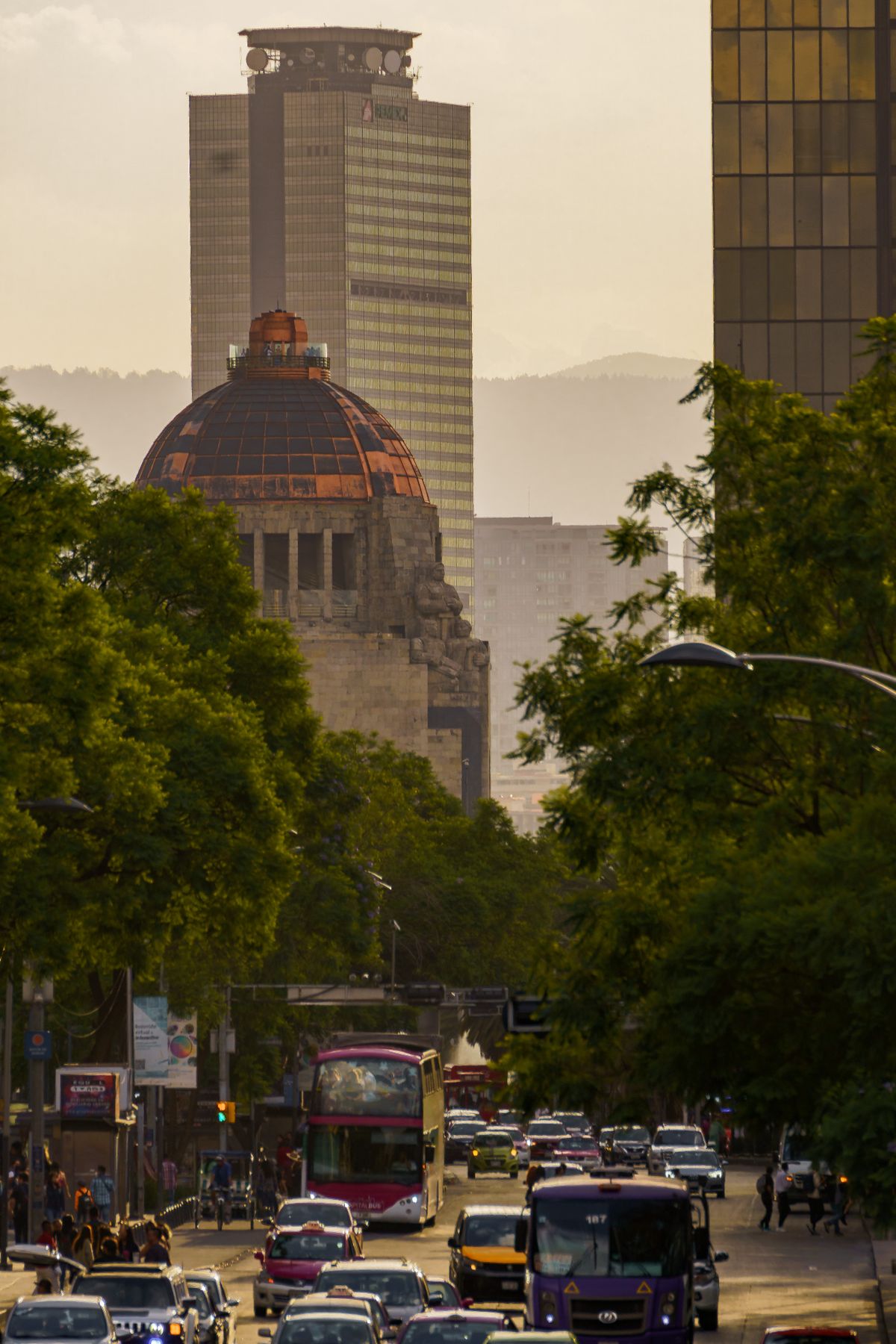 View of Mexico City urban traffic and Monument to the Revolution at sunset.