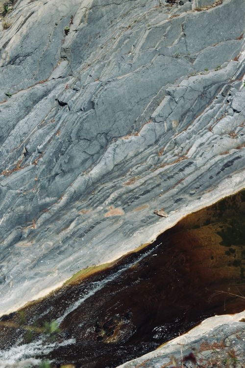 Free Top-view of eroded rock formations with a flowing river captured from above. Stock Photo