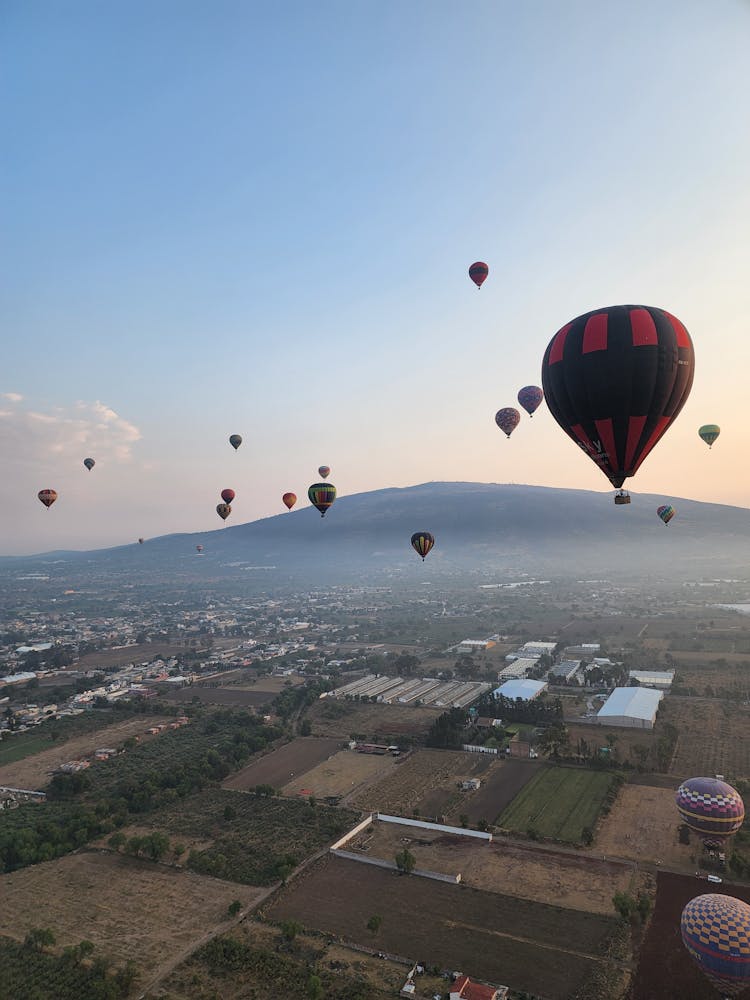 Balloons On Sky Over Town On Plains