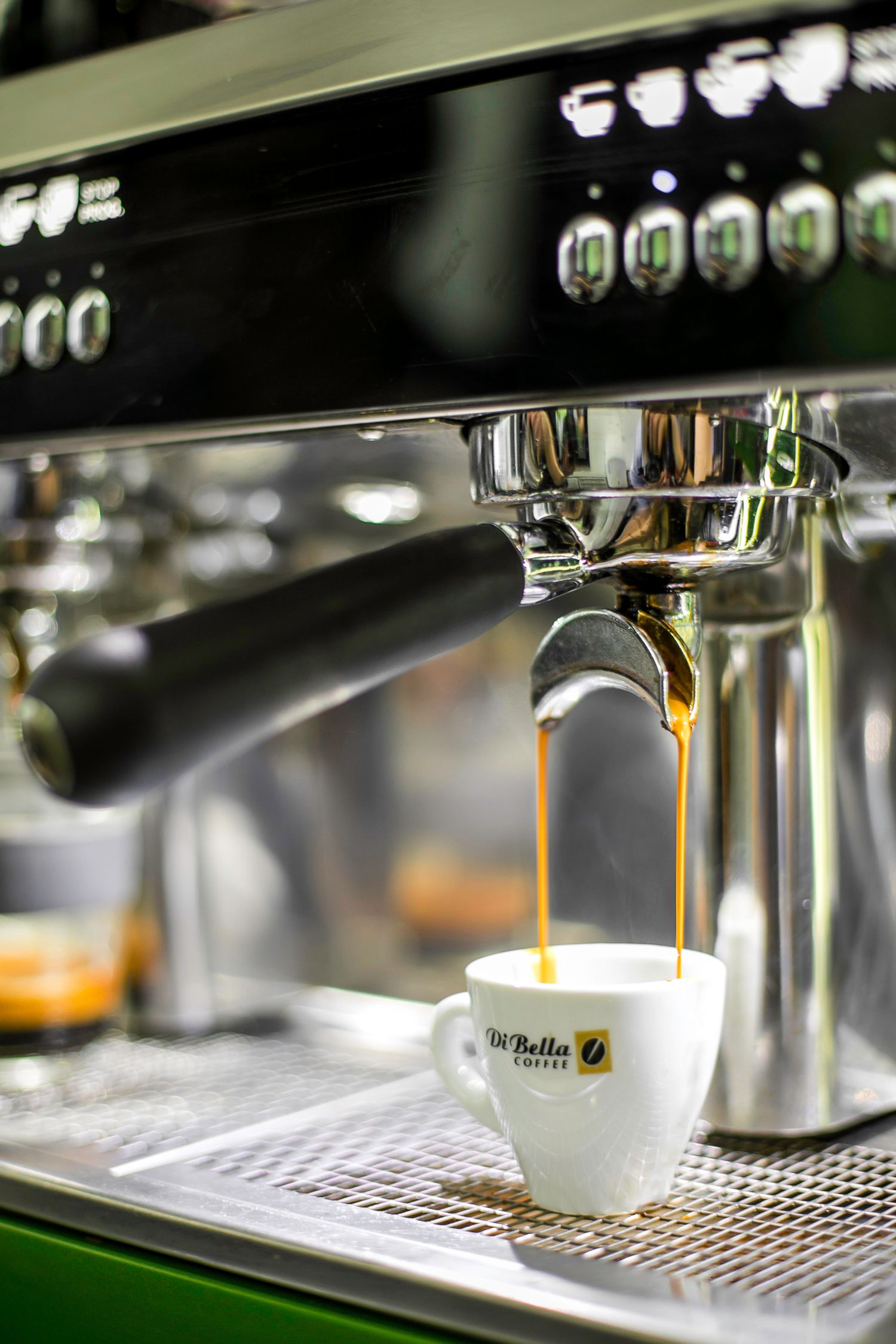 White Ceramic Di Bella Espresso Cup On Black And Gray Espresso Machine white-ceramic-di-bella-espresso-cup-on-black-and-gray-espresso-machine