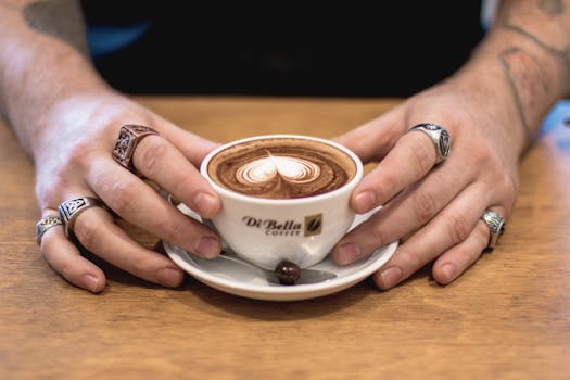 Close-up of a cappuccino in a café setting, captured indoors with artistic latte art.