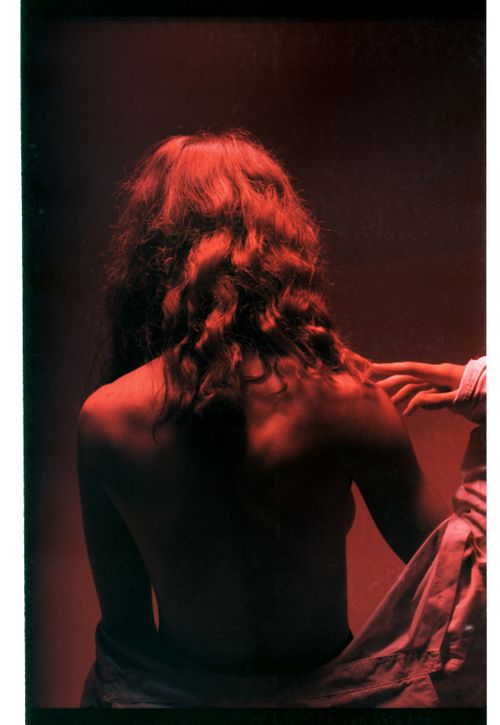 Free A captivating topless portrait with dramatic red lighting and an artistic touch. Stock Photo