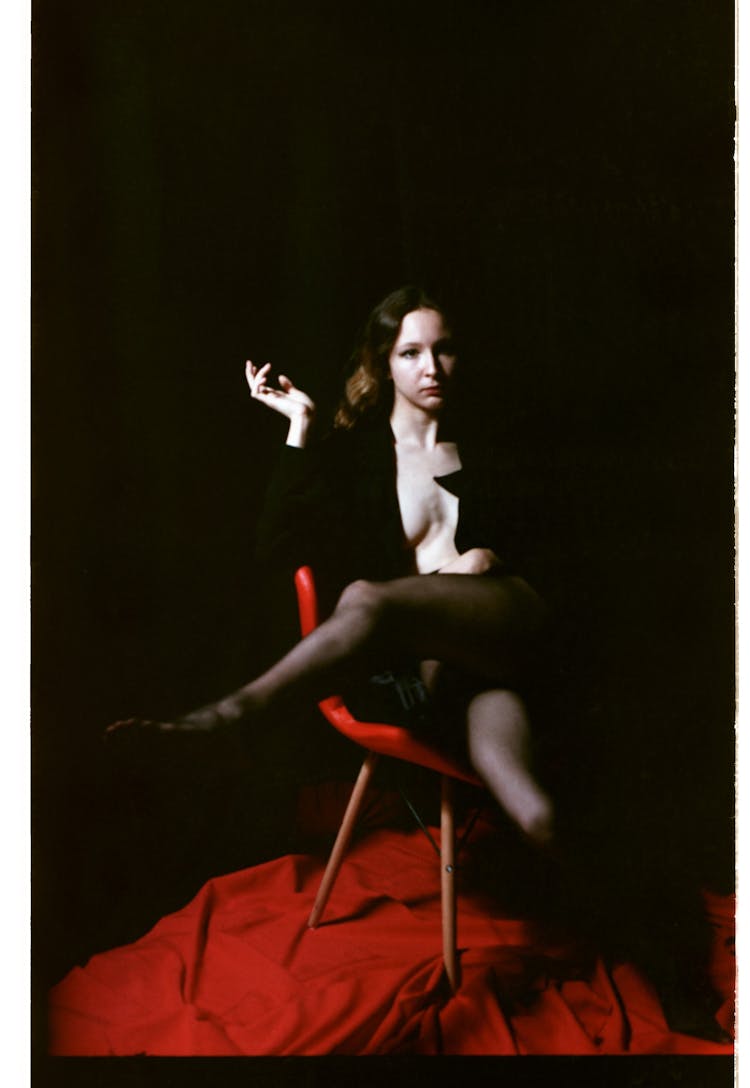 Woman Posing On Chair In The Dark 