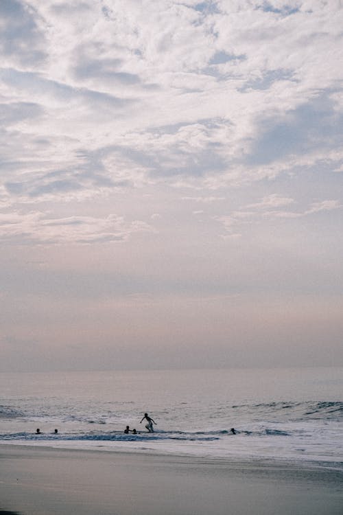 People Swimming on the Beach