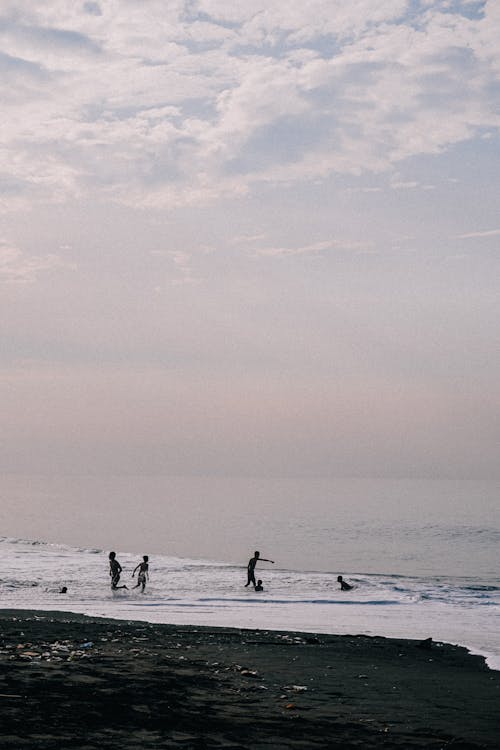 Silhouettes of People in Sea