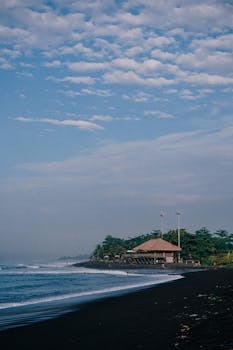 Beautiful black sand beach with a tranquil shore and scenic landscape, perfect for a serene getaway.