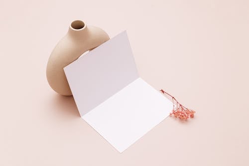 A Card and a Vase on Pink Background