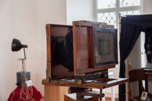 Free Close-up of a classic wooden box camera in a vintage studio environment. Stock Photo