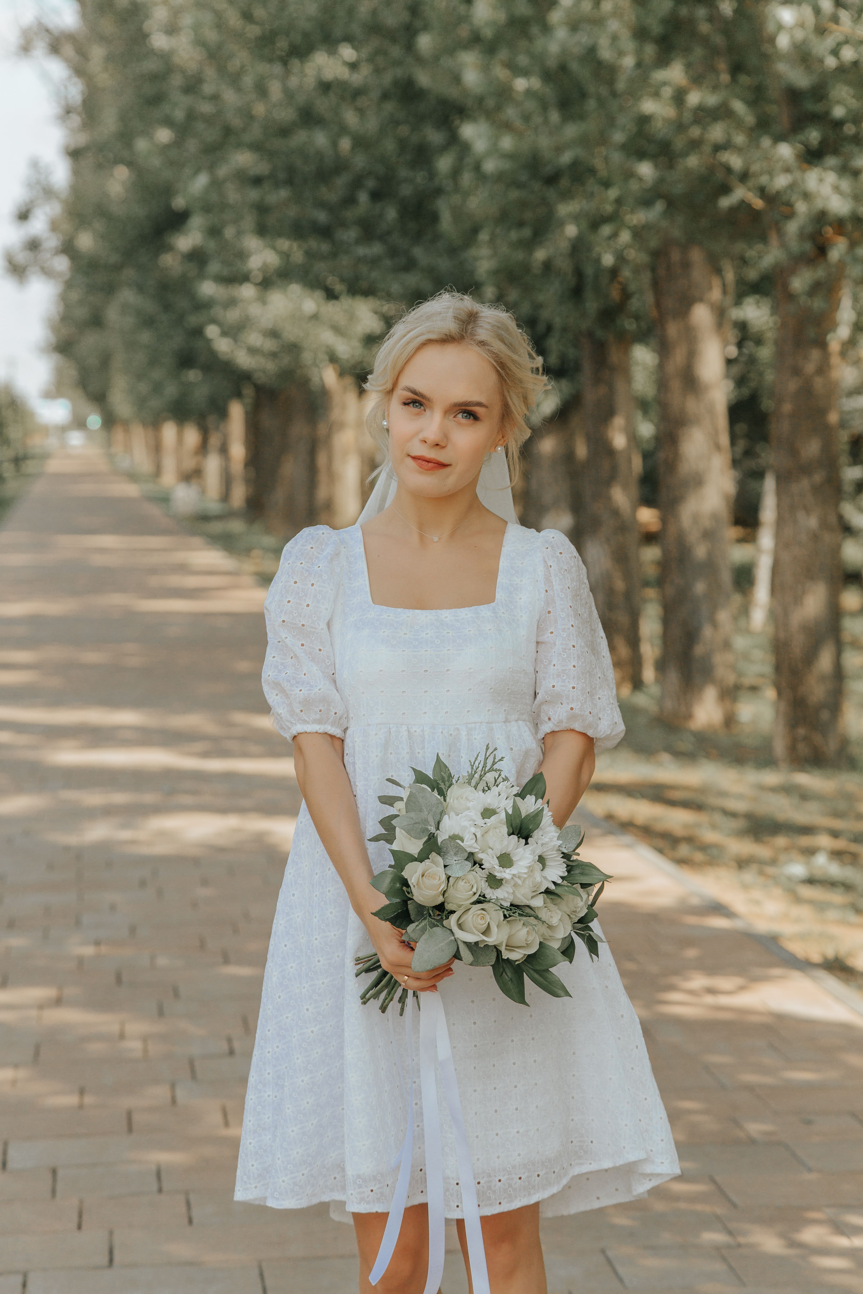 Woman in White Dress Holding Bouquet of Flowers · Free Stock Photo