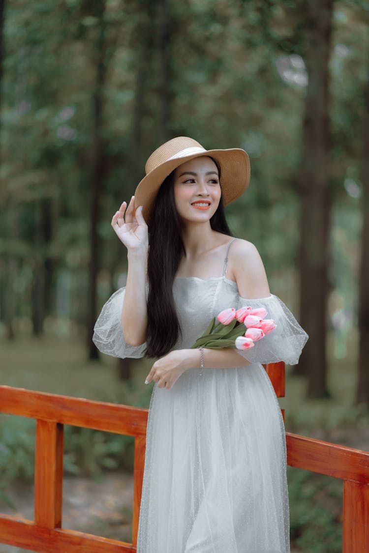 Woman In A Tulle Dress And A Hat Posing And Smiling 