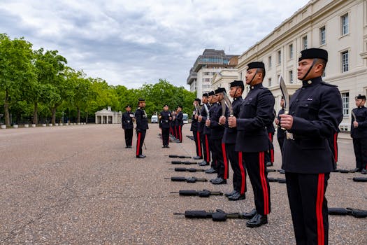 Gurkha soldiers in uniform holding kukris during a ceremony in London.