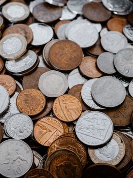 Detailed image of assorted coins from various currencies, showcasing metal textures and engravings.