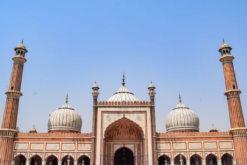 Free The iconic Jama Masjid mosque in Delhi with its impressive architecture against a blue sky. Stock Photo