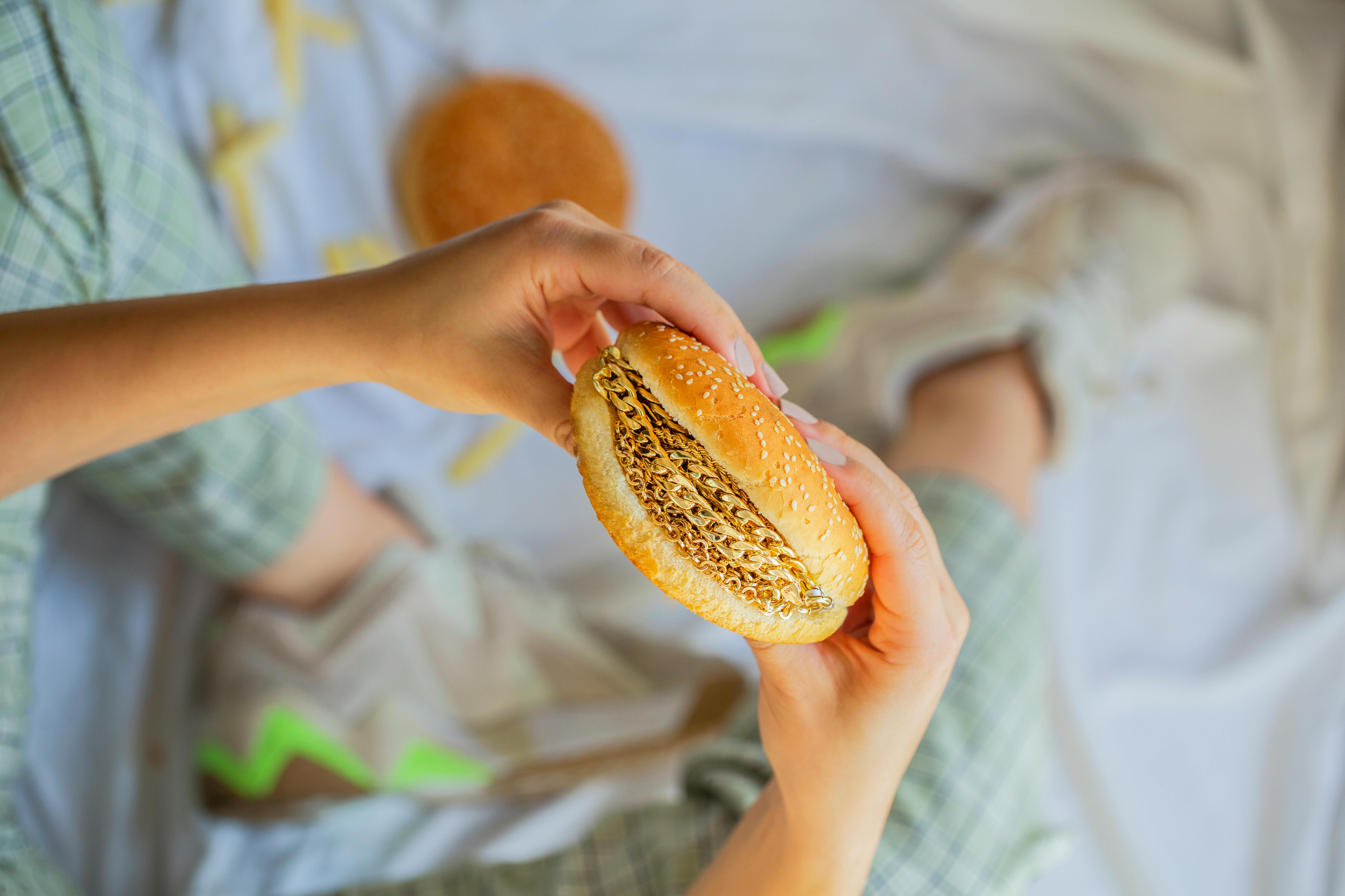 a person holding a hamburger