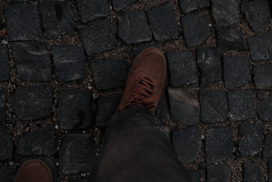 Comfortable, sturdy walking shoes on a cobblestone street in Bruges, Belgium
