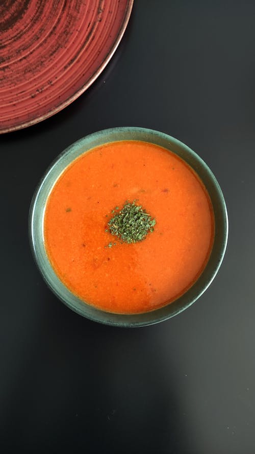 Orange Soup in Green Ceramic Bowl