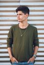 Man in Green Crew Neck Long Sleeve Shirt Wearing Silver Necklace