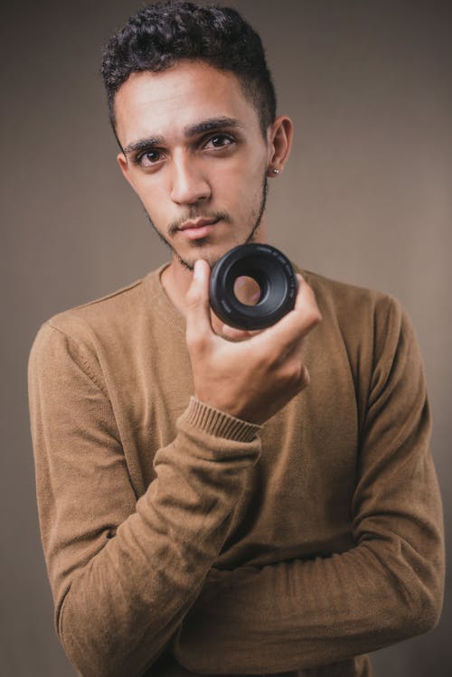 Man with Facial Hair Holding a Camera
