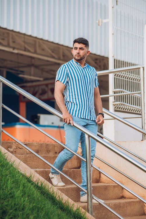 Man with Facial Hair Walking Down the Stairs