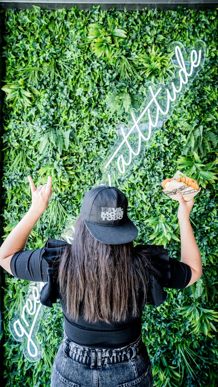 A Woman In Black Shirt Holding A Burger