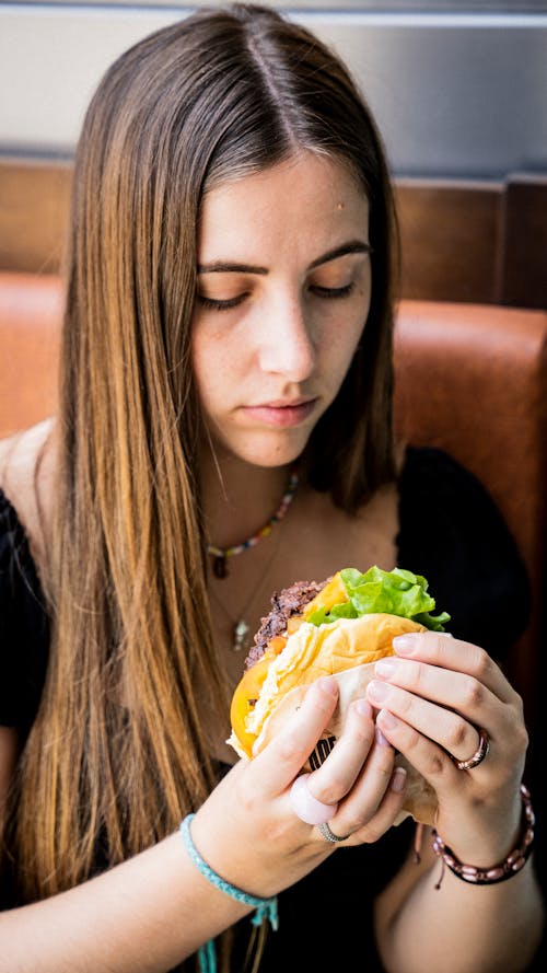 Young Girl Eating Hamburger