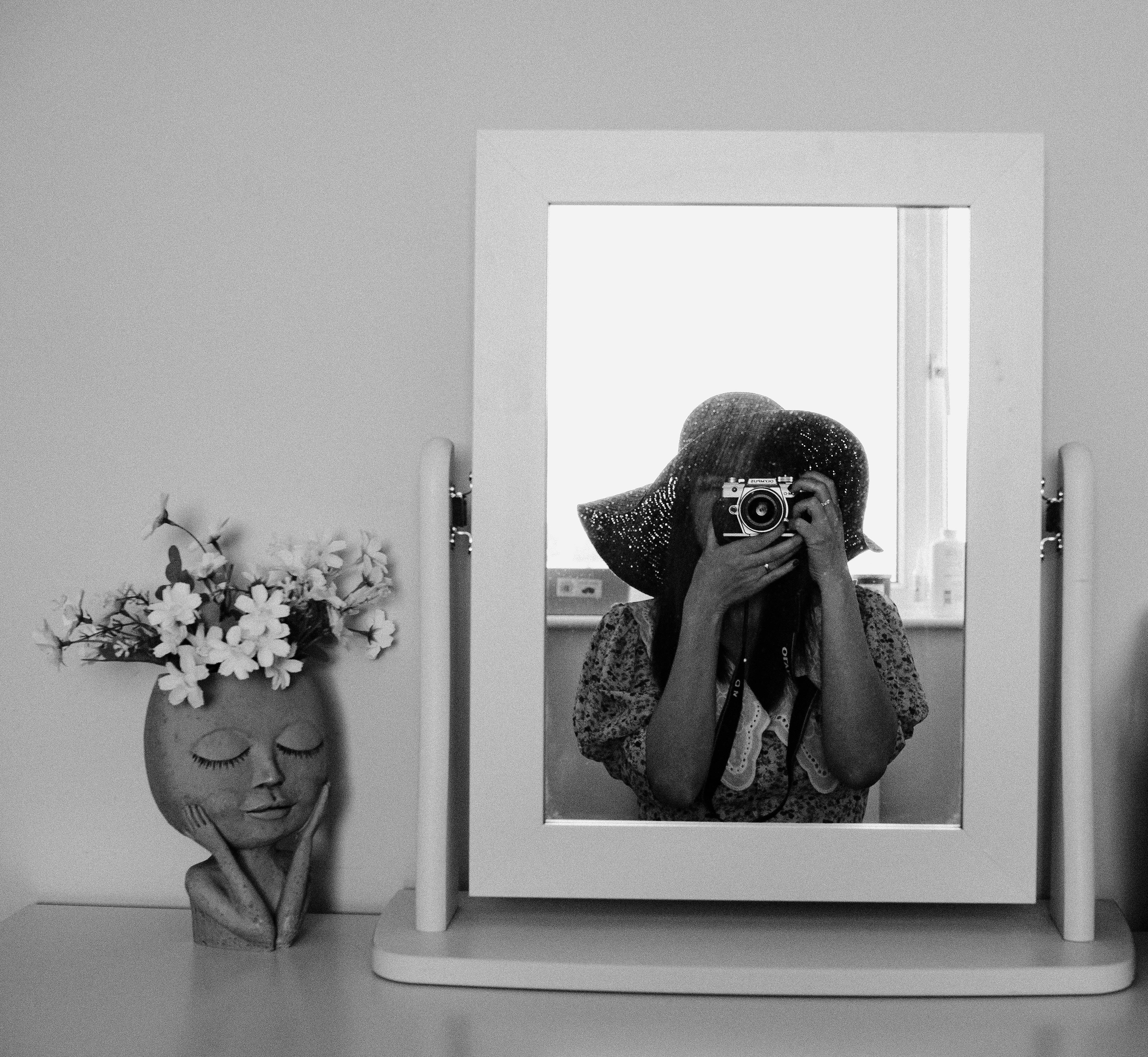 a woman taking a picture in the mirror
