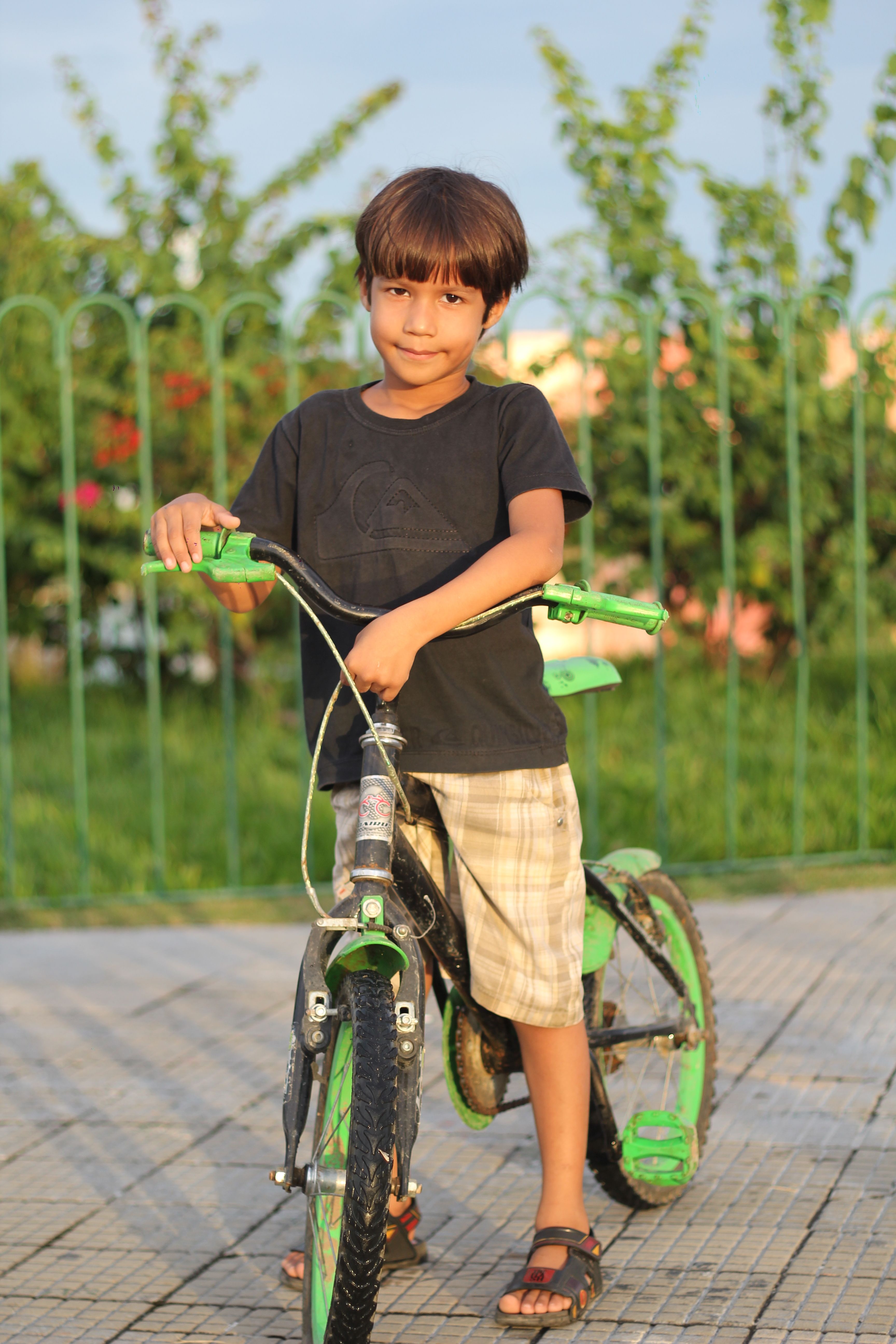 A Boy Riding Green and Black Bicycle · Free Stock Photo