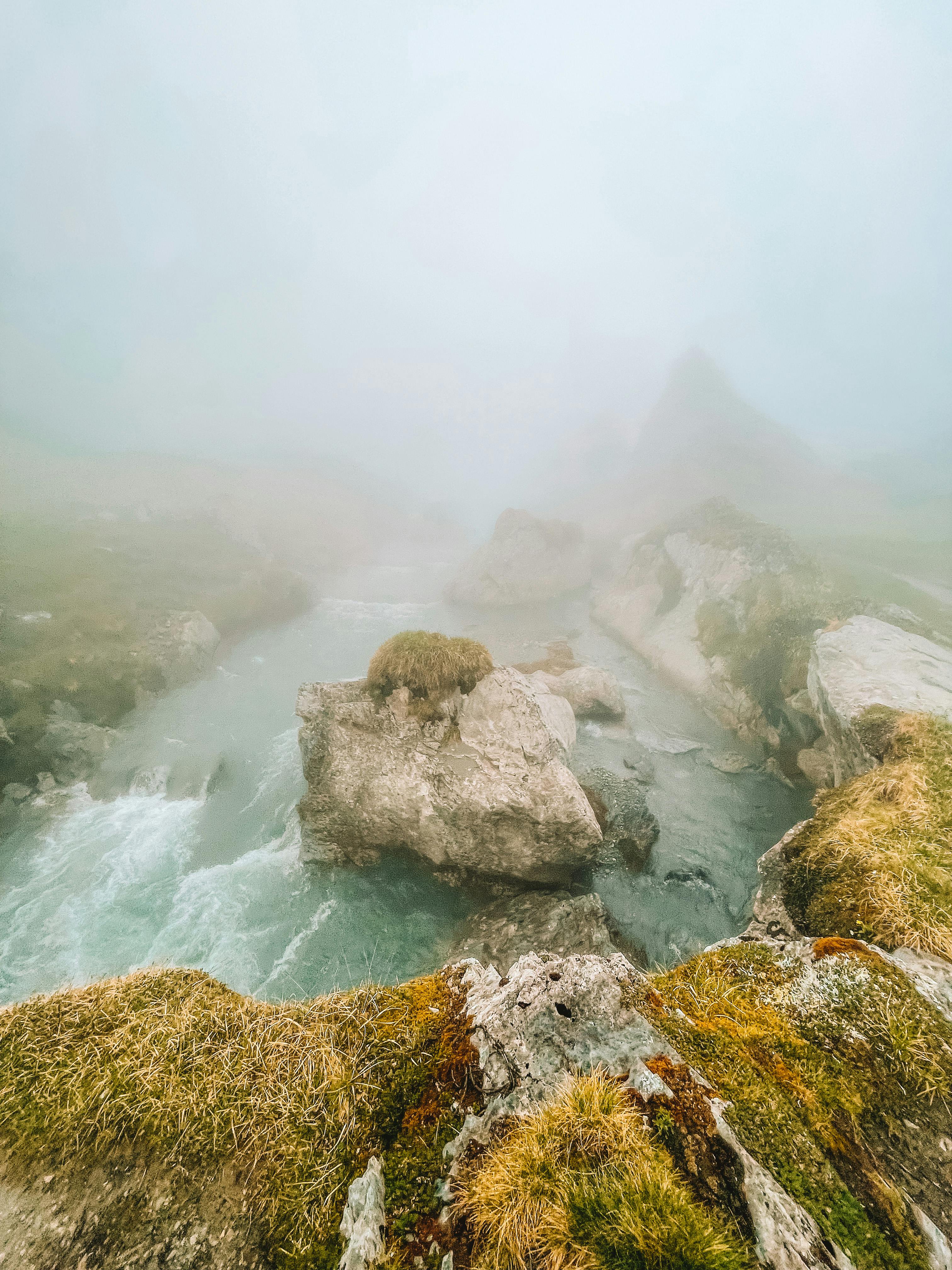 Serene misty river scene in the Swiss Alps, showcasing nature's tranquil beauty.