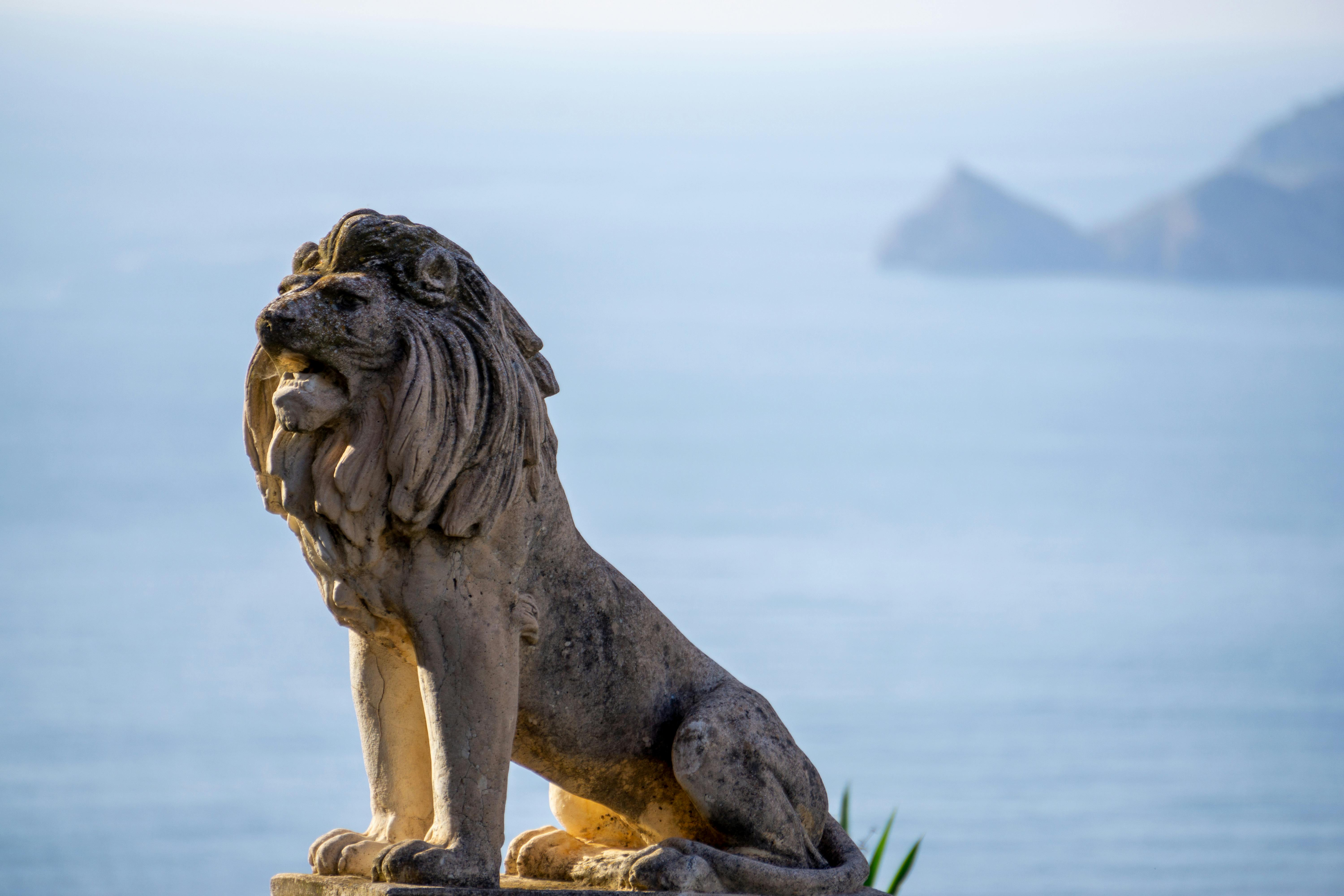 statue of a lion on the seaside