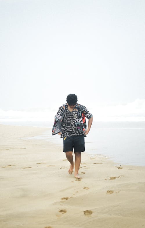 Free A Person Walking at a Beach Stock Photo