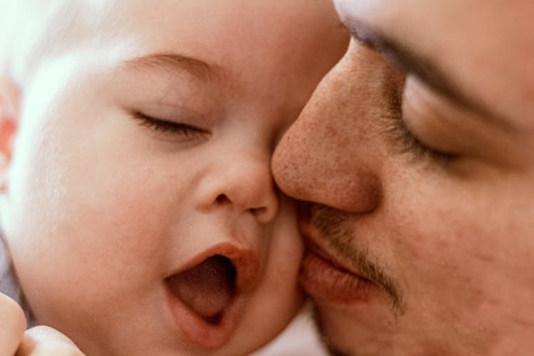 A Father Tender Care For A Baby