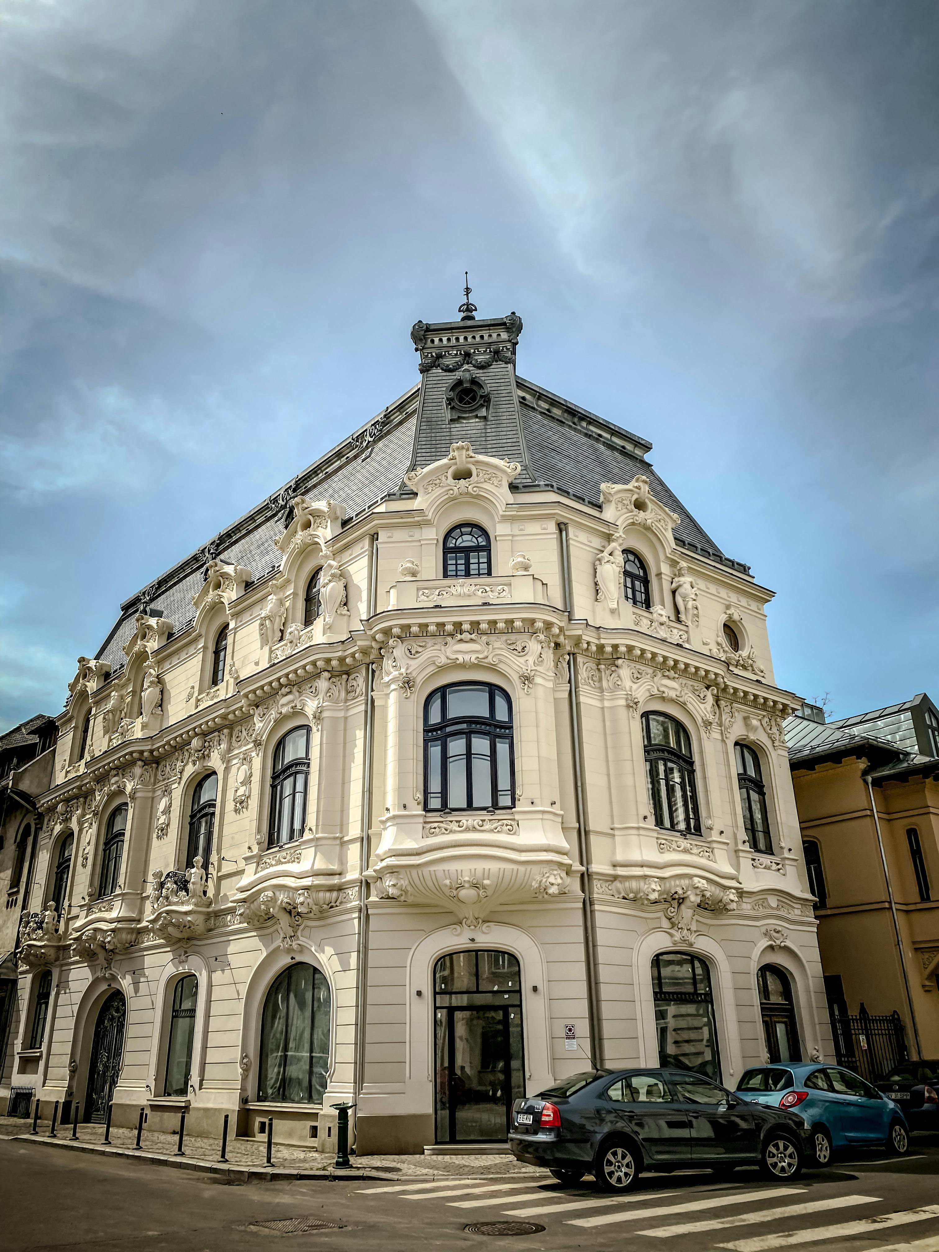 Free Elegant historical building with ornate facade in Bucharest on a cloudy day. Stock Photo