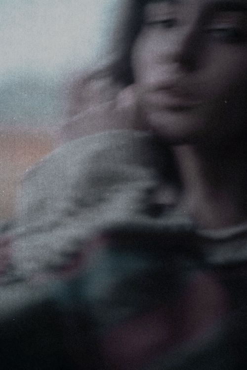 Free Artistic blurred portrait of a female with grainy texture, evoking mystery and emotion. Stock Photo