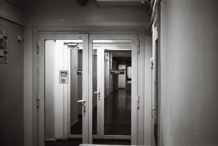 Black And White Photo Of Doors In Hospital Corridor