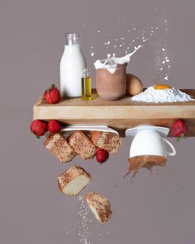 Floating strawberries and milk with splashes create a whimsical food art scene.