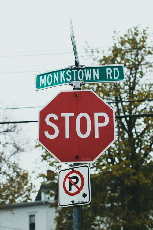 Free Red stop sign with street name and no parking sign on Monkstown Road. Stock Photo