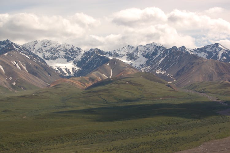 Mountain Ranges Under White Clouds