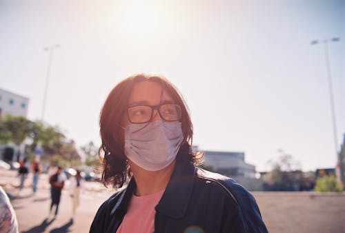 A Long Haired Teenager Wearing a Face Mask