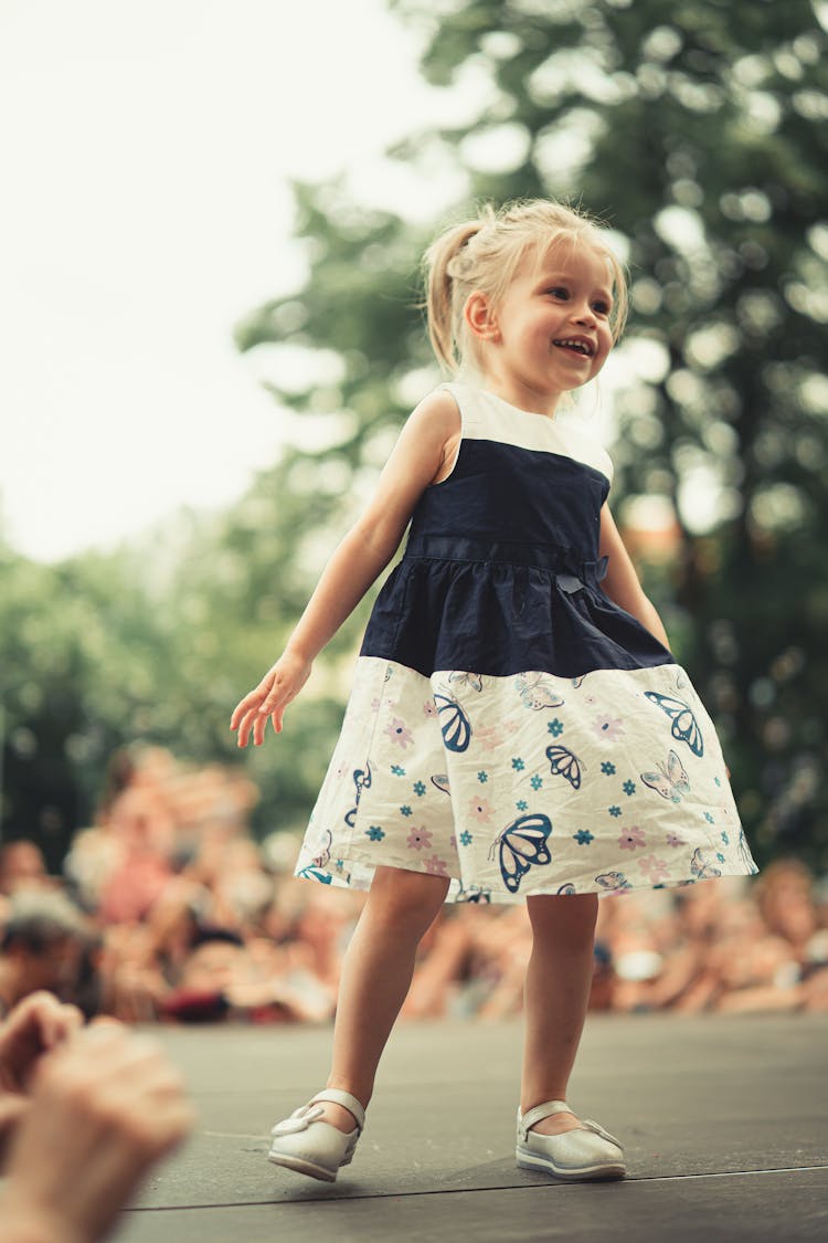 Little Girl Smiling On A Stage 