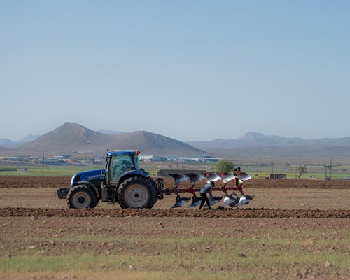 Man on Tractor Working in Field