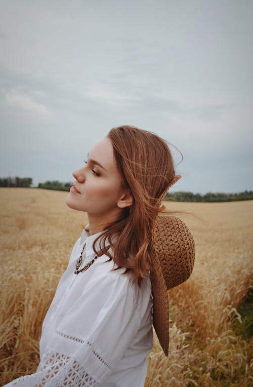 Woman in White Blouse Standing on Wheat Field