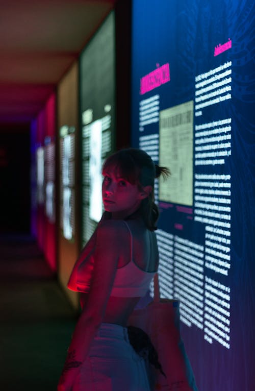 Woman in Dark Room with Digital Exhibition